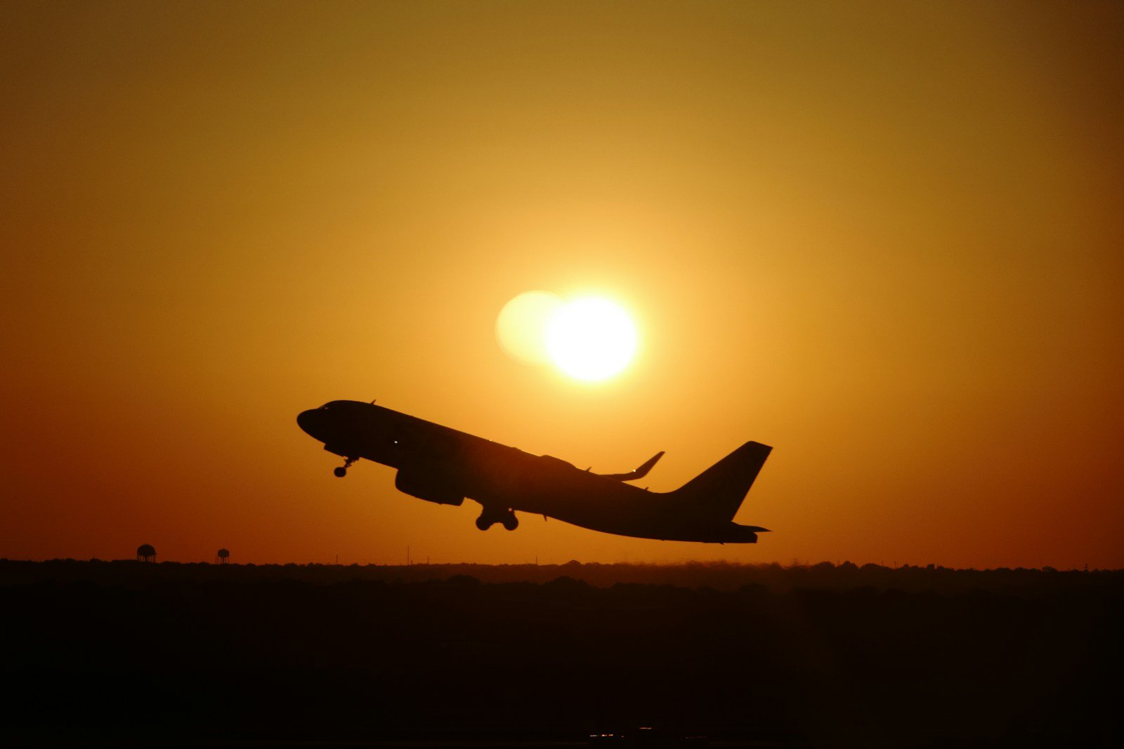 Cargo aircraft taking off against a warm evening sky